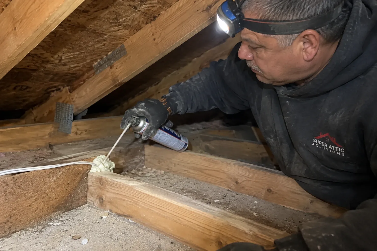 Air sealing a wire penetration in the attic top plate