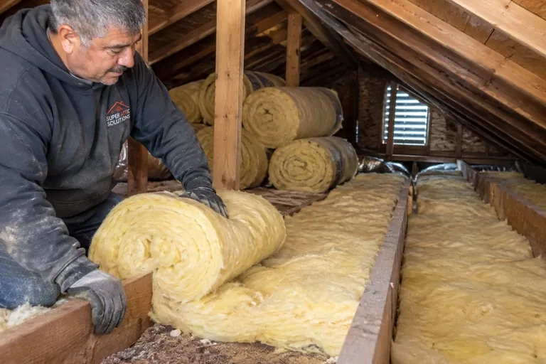 Fiberglass roll insulation installation