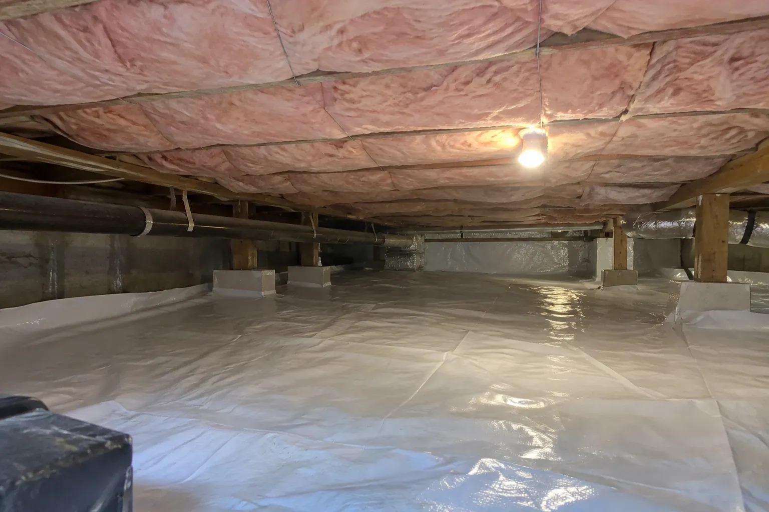 New crawl space insulation held in place under the floor