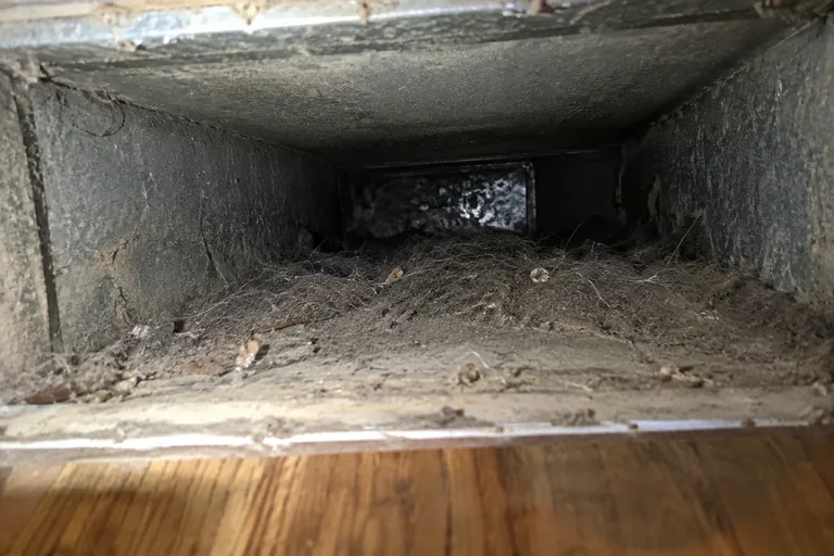 Before: dust-coated duct interior