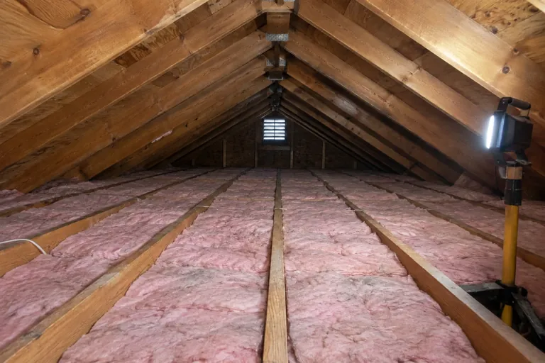 After: Firm mineral wool batts tight against the subfloor in every bay