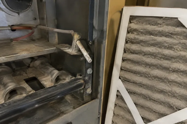 Before: Flame sensor rod coated in white residue; filter matted gray with dust