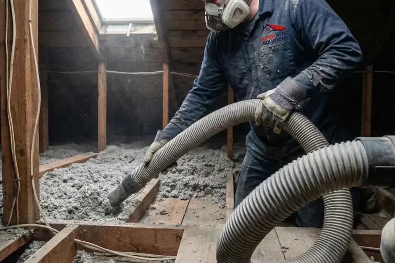 Insulation removal hose working through an attic