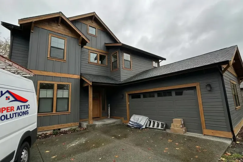 Super Attic Solutions van parked at a two-story Pacific Northwest home